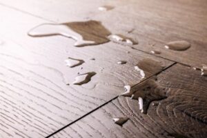 waterproof flooring spilled water drops on wooden laminate floor