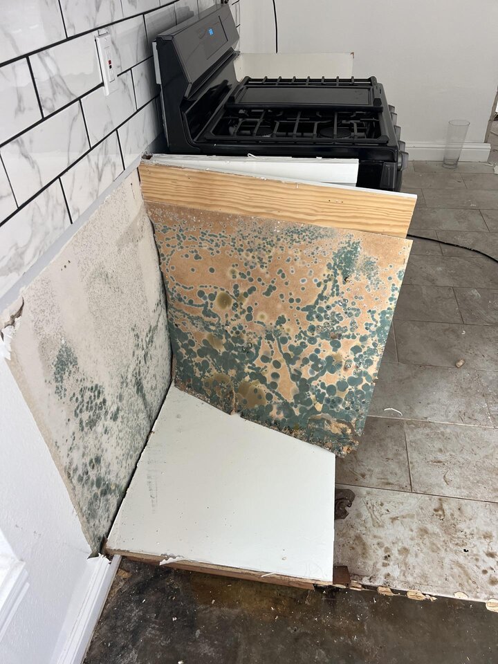Wall surface with visible mold and water damage staining from chronic moisture — in Texas, mold remediation is capped at $5,000–$25,000 on most homeowners policies, creating a coverage gap when AC overflows go undetected for more than 48 hours