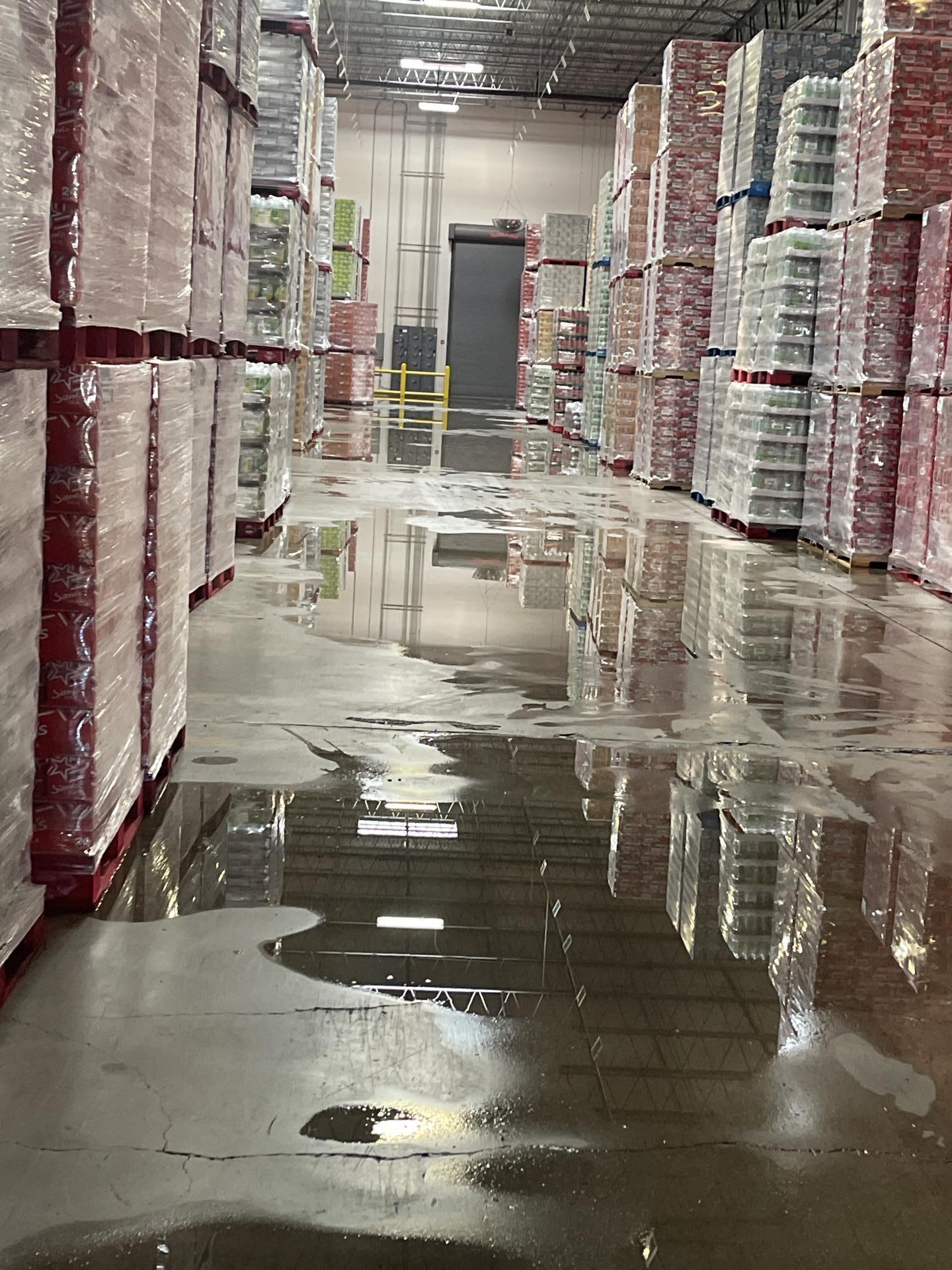 Standing water in a commercial warehouse aisle