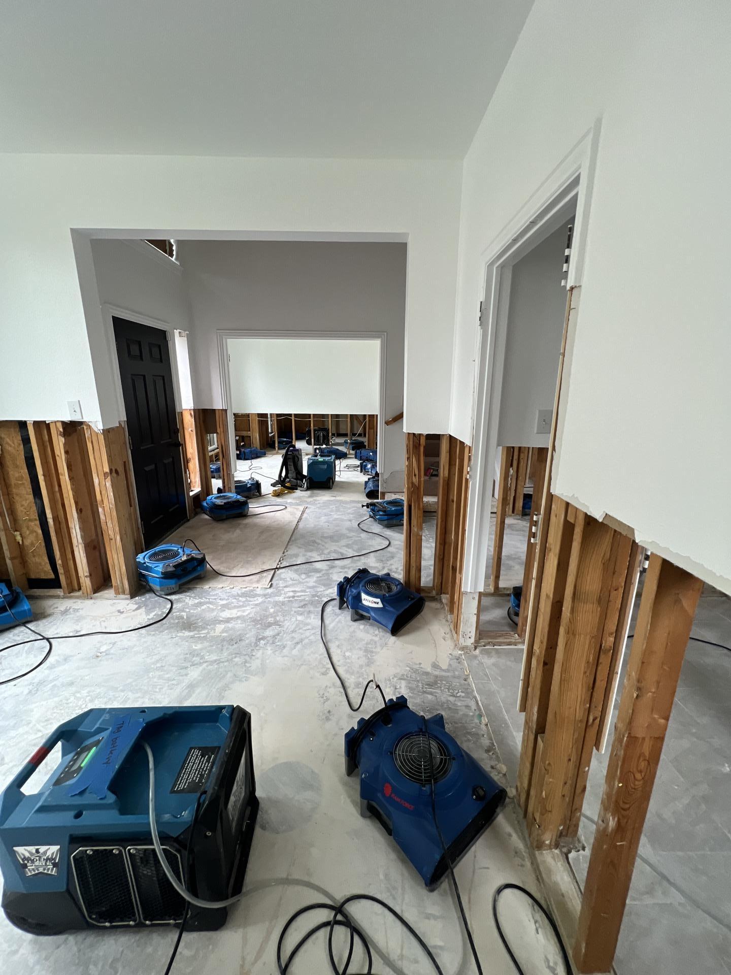 Hallway with drywall flood cuts and structural drying equipment