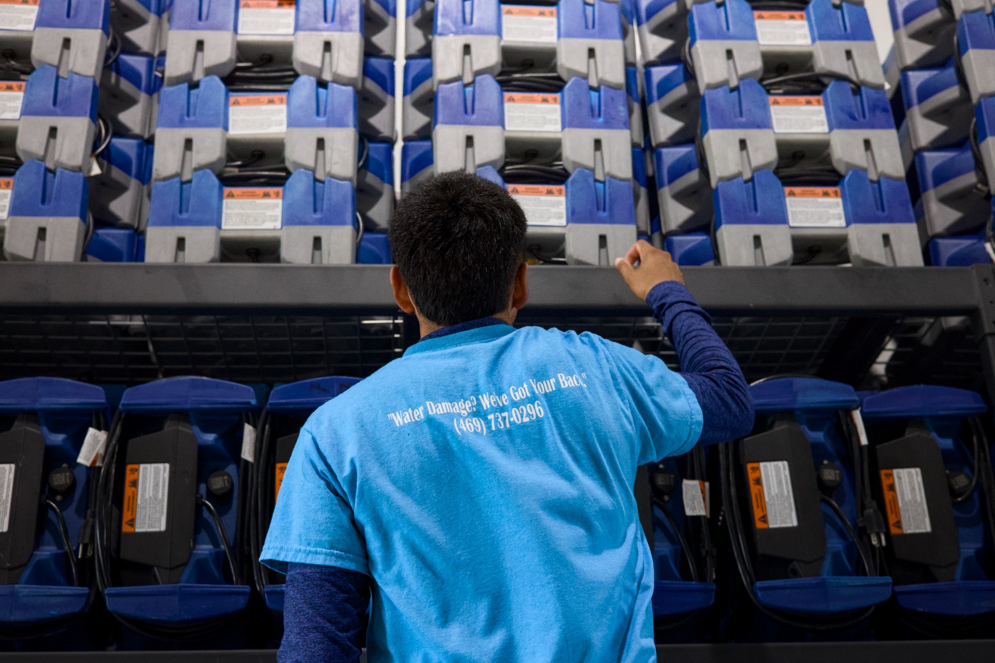 SS Water Restoration technician selecting equipment in the warehouse